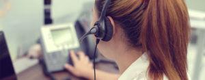 woman wearing headset answering help desk calls